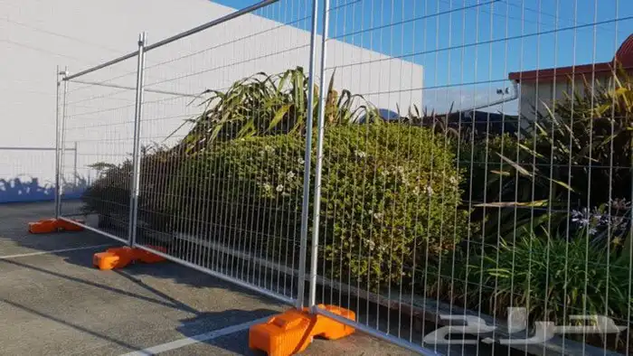 Galvanized welded temporary fence panels set on the plates 10