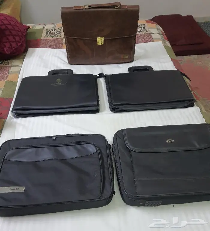 شنطة يدوية وشنطة لاب توب وحافظة دفتر وقلم مختلفة الأشكال 0