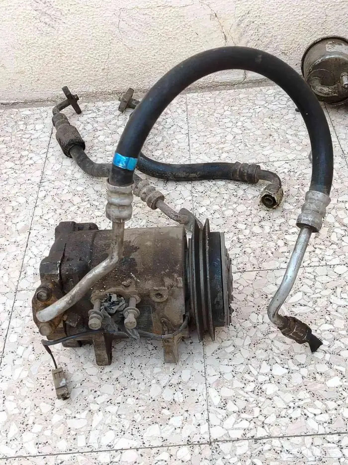 كربريتر سيدريك نيسان وكمبروسر وطبلون وقطع اخري 9